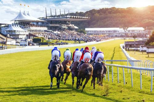 a group of jockeys riding horses on a race track at Insta-worthy 4br designer house 5 min to the beach in West Wittering