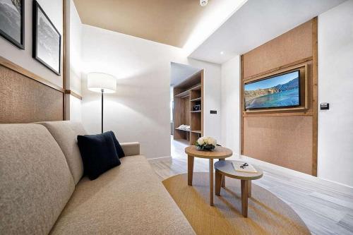 a living room with a couch and a table at H10 Costa Mogán - Adults Only in Playa del Cura