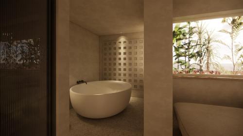 a bathroom with a tub and a large window at La Gaia - Adult Only in Alanya