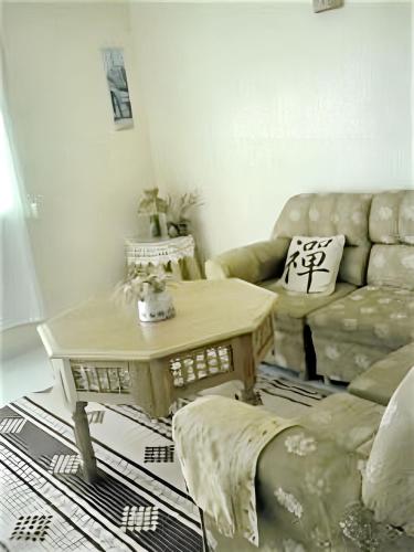 a living room with a couch and a coffee table at Spacious Apartment in Asilah with Pool and Garden in Asilah
