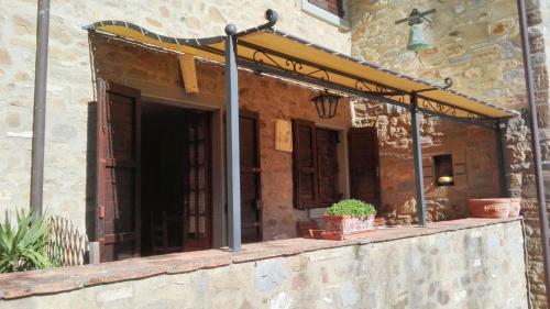 a building with a porch with potted plants on it at Spacious Apartment in Lisciano Niccone with Mountain View in Mercatale