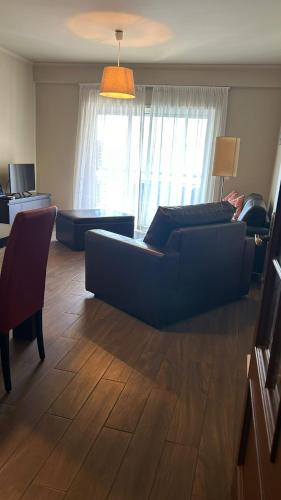 a living room with a couch and a table at Pórtico de Malpique in Albufeira