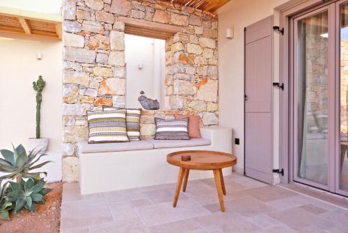 a porch with a couch and a table at Agave Donousa Suites in Donoussa