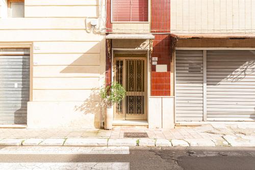 a door of a building with a potted plant at Cod 278 al centro del paese in Ugento