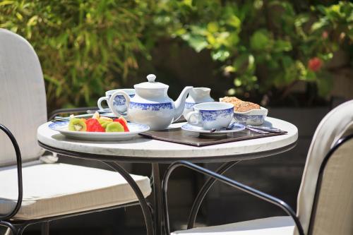 a table with a teapot and a plate of fruit at Hotel Boutique Le Reve in Santiago