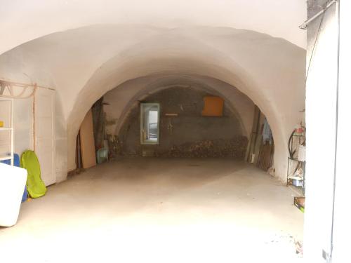 an empty hallway in a building with a tunnel at Maison chaleureuse près des pistes de Barcelonnette - Cheminée in Barcelonnette