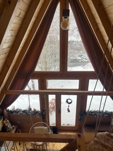 a window in a cabin with snow on the ground at Holiday Home Veruša in Podgorica