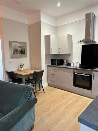 a kitchen with a couch and a table in a room at Church Street Apartments in Kidderminster