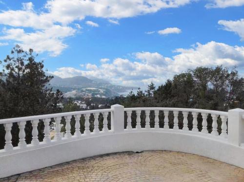 a white balcony with a view of a city at Sophisticated Villa in Sant Josep de sa Talaia with Private Pool in Sant Josep de Sa Talaia