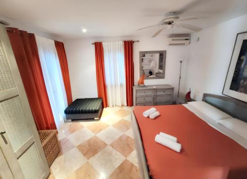 a bedroom with a red table and a chair at Sophisticated Villa in Sant Josep de sa Talaia with Private Pool in Sant Josep de Sa Talaia