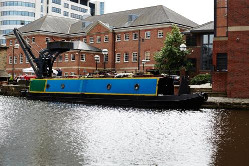 a boat is docked on a river in a city at DoubleTree by Hilton Leeds in Leeds