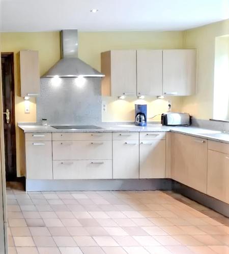 a kitchen with white cabinets and white appliances at Spacious house with garden in Comblain-au-Pont in Comblain-au-Pont