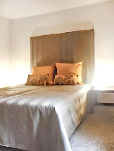 a bedroom with a large bed with a large headboard at Spacious house with garden in Comblain-au-Pont in Comblain-au-Pont