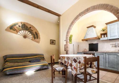 a kitchen with an archway and a table in a room at Charming Apartment in Massa Marittima, Shared Pool in Massa Marittima