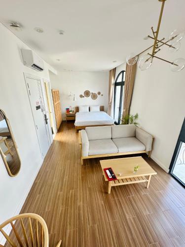 a living room with a couch and a bed at Aqua Vista Phu Quoc in Phú Quốc