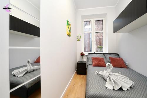 a bedroom with two beds and a window at MMRent Mystic Room in Gdańsk