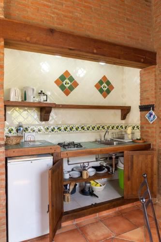a kitchen with a sink and a stove top oven at Charming cabin with Scenic view in Tepoztlán in Tepoztlán