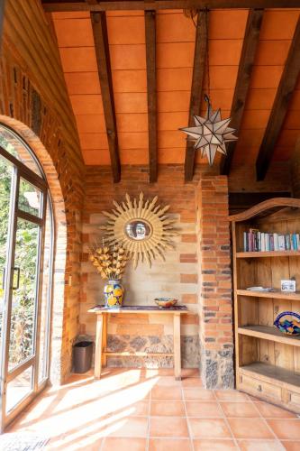 a room with a wooden wall with a table and a mirror at Charming cabin with Scenic view in Tepoztlán in Tepoztlán