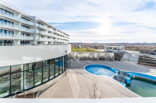a view of a building with a swimming pool at FARO Apartamenty Polanki Aqua SPA Deluxe 4 baseny w cenie, Pools inklusive in Kołobrzeg
