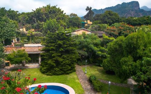 an aerial view of a garden with a swimming pool at Charming cabin with Scenic view in Tepoztlán in Tepoztlán