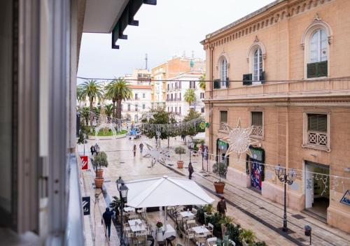 a view of a city street with tables and buildings at Stone House in Taranto
