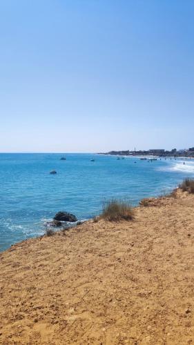 a view of the ocean from a sandy beach at Ghar el melh in Ghār al Milḩ