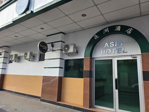 a asia hotel building with a glass door at Asia Hotel by AeCOTEL in Sandakan
