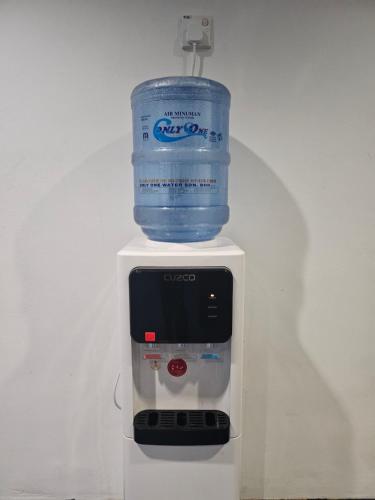 a bottle of water sitting on top of a machine at Asia Hotel by AeCOTEL in Sandakan