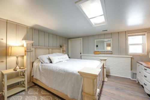 a bedroom with a white bed and a skylight at Cozy Table Rock Lake Boathouse with Pool Access in Cape Fair