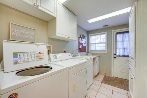 a kitchen with white cabinets and a sink at Cozy Table Rock Lake Boathouse with Pool Access in Cape Fair