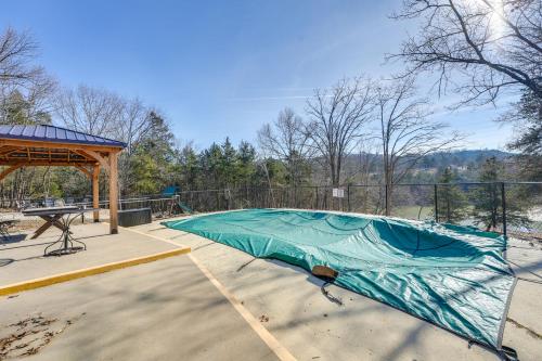 a green tarp on top of a golf course at Cozy Table Rock Lake Boathouse with Pool Access in Cape Fair