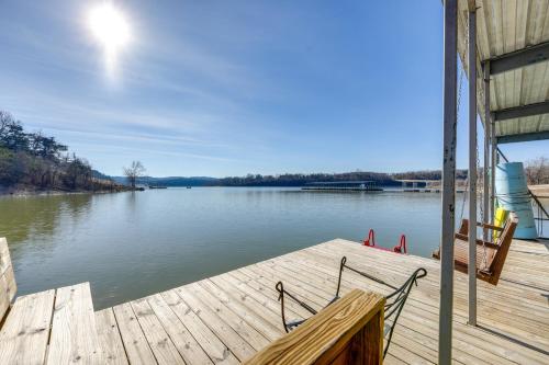 a wooden dock with a bench on the water at Cozy Table Rock Lake Boathouse with Pool Access in Cape Fair