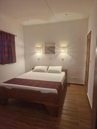 a bedroom with a large bed in a room at cazasamba in Cap Skirring