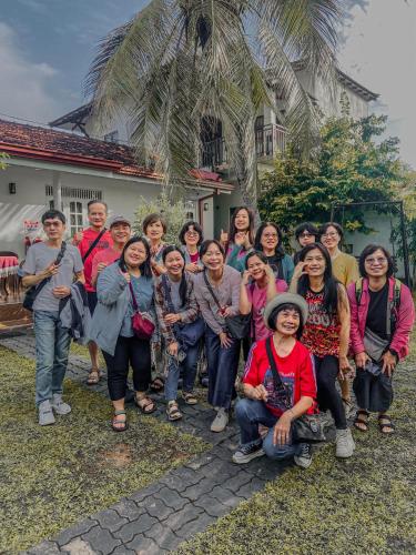 a group of people posing for a picture in front of a house at White Villa Airport Transit Hotel in Katunayake