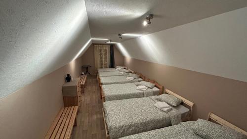 a row of beds lined up in a room at Saliņas in Krāslava