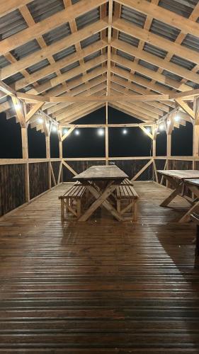 a room with picnic tables and lights on a wooden floor at Saliņas in Krāslava