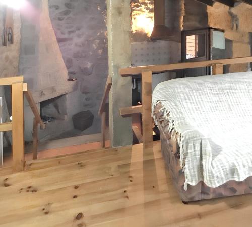 a bedroom with a bed and a wooden floor at House with Shared Pool in Águeda, Mountain View in Urgueira