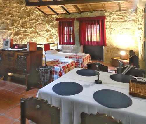 a room with several tables with white table cloth at Cozy house in Águeda 45 m² with shared pool in Urgueira