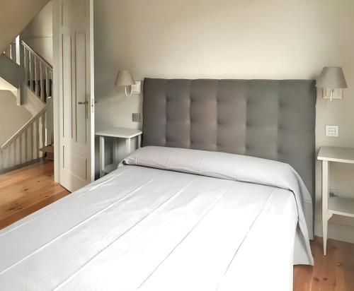 a bedroom with a large bed with a large headboard at Beautiful Holiday Home in Po de Llanes with Sea View in poo de Llanes