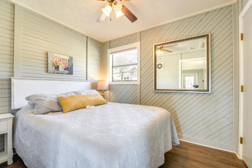 a bedroom with a bed with a ceiling fan and a mirror at Bass Fishing Paradise Cottage on Table Rock Lake in Cape Fair