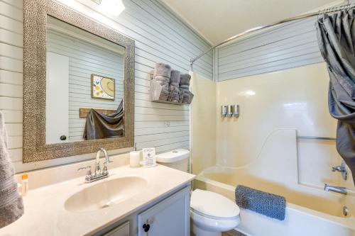 a bathroom with a sink and a toilet and a mirror at Bass Fishing Paradise Cottage on Table Rock Lake in Cape Fair
