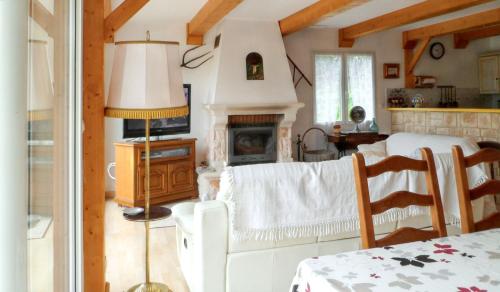 a kitchen with a living room with a fireplace at Maison chaleureuse à Nages avec vue sur lac et montagne in Nages