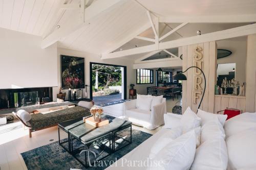a living room with a white couch and a table at Villa Grand Marchais in Les Portes