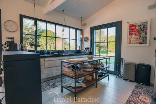 a kitchen with a counter and some windows at Villa Grand Marchais in Les Portes
