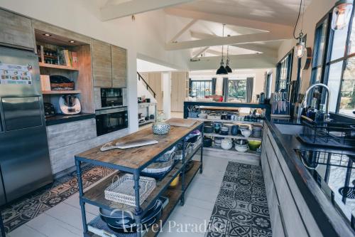 a large kitchen with a wooden counter in it at Villa Grand Marchais in Les Portes