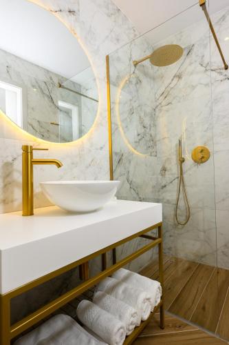 a bathroom with a sink and a mirror at XVI Suites - Adults Only in Naxxar