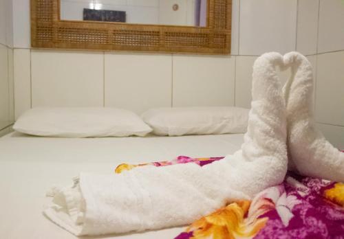 a pair of legs laying on a towel on a table at Pousada Mar do Sonho Vila in Porto De Galinhas