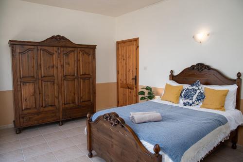 a bedroom with a large bed with blue and yellow pillows at Seafront Bedroom with stunning views, balcony and en-suite in Marsaskala
