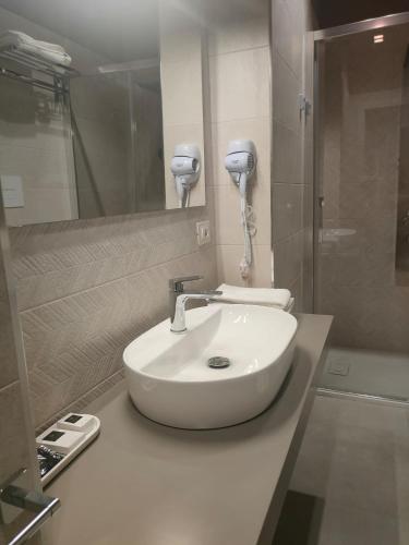 a bathroom with a white sink and a mirror at Malva B&B in Reggio Calabria