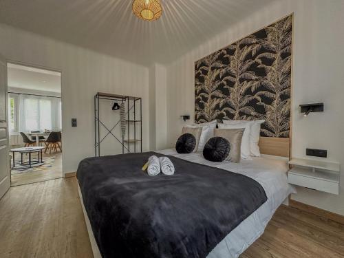 a bedroom with a large bed with shoes on it at MonHac - Modern and comfortable flat in Luisant